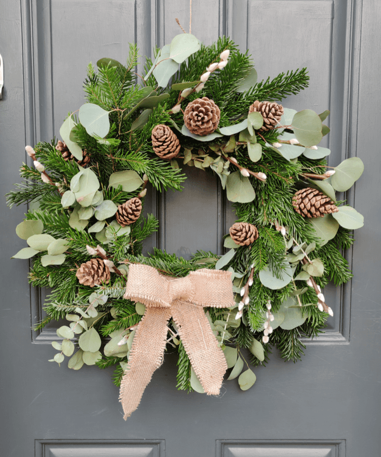 This elegant wreath boasts beautiful constrasts of green from pine, two varieties of eucalyptus and the white glow from pussy willow. Finished with a hessian bow to complete the natural look. This wreath is 100% compostable and plastic free.